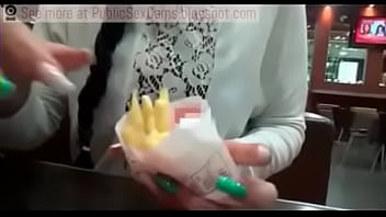 Девушка ест публичный камшот на картофель фри
