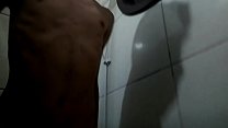 Young man taking a shower in white underwear