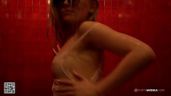 Young blond girl having fun and masturbating under the shower