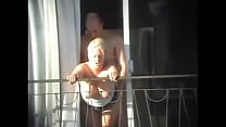 gxquual couple having sex on the balcony of the building