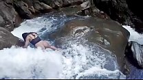 Lilyan takes a very daring dip at the edge of a waterfall