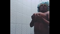Solo Ebony Becky taking a hot shower in a bathroom