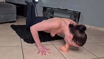 skinny slut doing pushups while gagging on a dildo topless