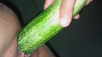 Teasing the pussy hole with a cucumber, the mistress stuffs it in the pussy, then spreads the student girl's pussy and uses the cock to fuck the clit.